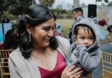 Photo of Sara (left) holding her child (right).