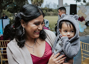 Photo of Sara (left) holding her child (right).